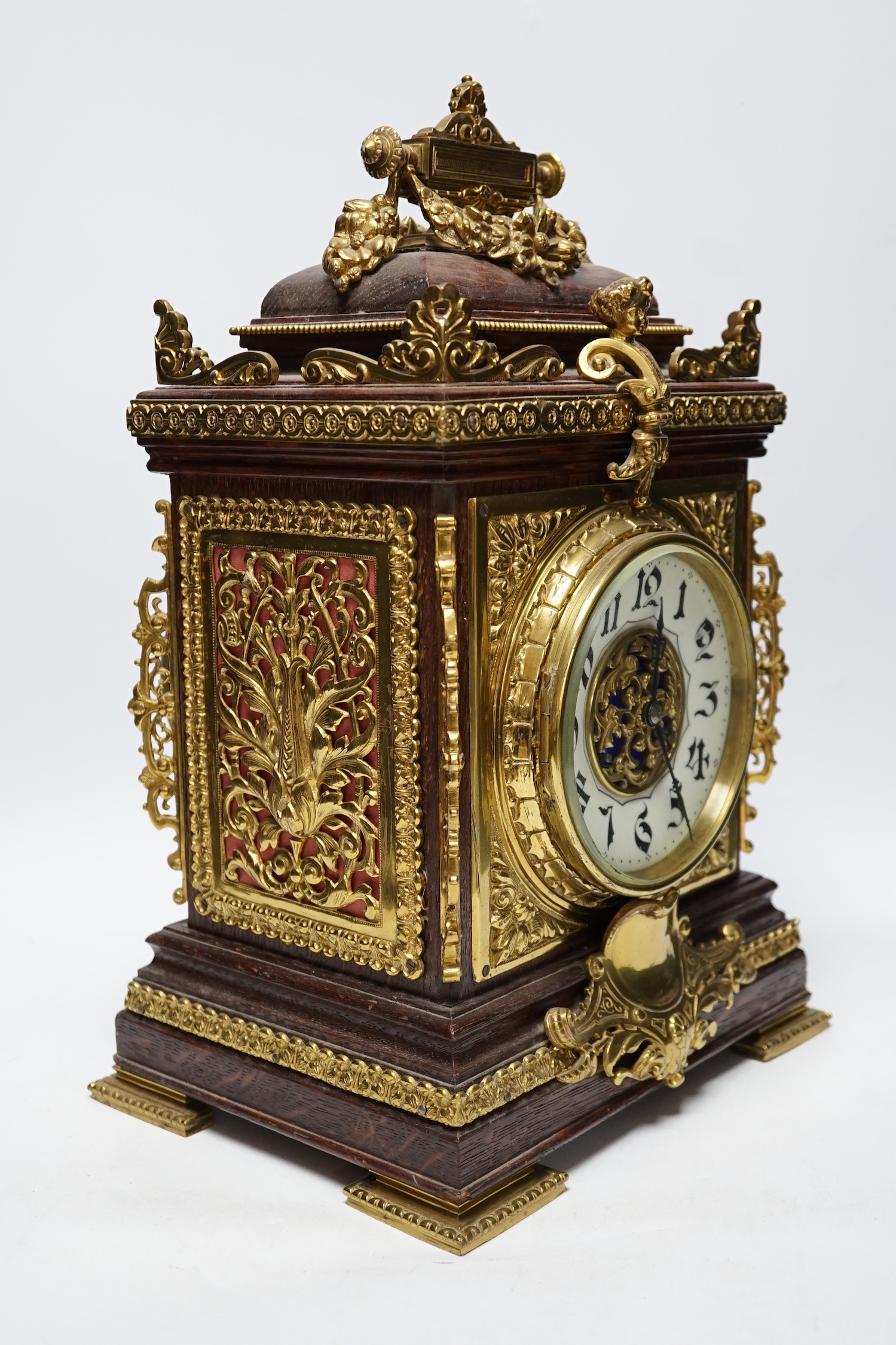 A French oak and brass mounted mantel clock with enamel dial, 42cm high